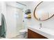 Modern bathroom featuring a glass-enclosed shower, a wood vanity, and stylish fixtures at 1785 Bayshore Dr, Englewood, FL 34223