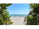 Picturesque beach scene with soft sand and clear blue water, perfect for relaxation and recreation at 1785 Bayshore Dr, Englewood, FL 34223