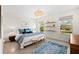Bedroom with serene decor, natural lighting and decorative rug at 1785 Bayshore Dr, Englewood, FL 34223
