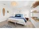 Bright bedroom featuring a king-size bed with blue accents and unique surfboard decor at 1785 Bayshore Dr, Englewood, FL 34223