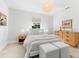 Bright bedroom with a king-size bed, woven dresser, and stylish decor at 1785 Bayshore Dr, Englewood, FL 34223
