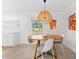 Cozy dining area with a round table, stylish lighting, and bright artwork at 1785 Bayshore Dr, Englewood, FL 34223
