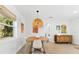 Elegant dining area featuring a round table, woven pendant light, and natural decor at 1785 Bayshore Dr, Englewood, FL 34223