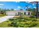Charming one-story home with a well-manicured lawn, attached garage, and delightful curb appeal at 1785 Bayshore Dr, Englewood, FL 34223