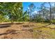 Image of a spacious land with trees, ideal for building a custom home in a serene setting at 1785 Bayshore Dr, Englewood, FL 34223