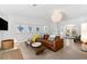 Cozy living room featuring a leather sofa, eclectic decor, and ample light at 1785 Bayshore Dr, Englewood, FL 34223