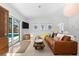Comfortable living room with a plush leather sofa, stylish decor, and natural light, creating a relaxing atmosphere at 1785 Bayshore Dr, Englewood, FL 34223