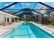 Inviting screened-in pool area with lounge chairs, perfect for relaxation and enjoying the Florida sunshine at 1785 Bayshore Dr, Englewood, FL 34223
