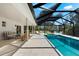 Stunning pool area with sun loungers and a screened enclosure, offering privacy and shade at 1785 Bayshore Dr, Englewood, FL 34223
