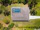 Aerial view of the screened-in pool area, perfect for relaxation and entertaining. Lush landscaping surrounds the home at 1785 Bayshore Dr, Englewood, FL 34223
