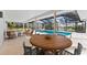 Inviting screened-in pool area with comfortable seating and lush landscaping at 1785 Bayshore Dr, Englewood, FL 34223