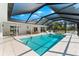 Beautiful covered pool area with in-ground pool and lounge area, perfect for outdoor entertaining at 1785 Bayshore Dr, Englewood, FL 34223