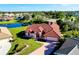 Stunning single-story home with tile roof, brick driveway, water view, and lush landscaping at 1886 Killdeer Ct, Venice, FL 34293