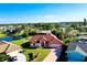 Aerial view of the property with lake view and lush landscaping at 1886 Killdeer Ct, Venice, FL 34293