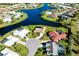 Aerial view of neighborhood with water views and beautiful landscaping at 1886 Killdeer Ct, Venice, FL 34293