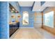 Elegant bathroom features double vanities, stylish mirrors, an arched window, and a tiled walk-in shower at 1886 Killdeer Ct, Venice, FL 34293