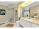 Bathroom features a glass shower, geometric wallpaper, a large mirror, and ample vanity space at 1886 Killdeer Ct, Venice, FL 34293
