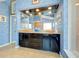 Stylish bathroom featuring double vanities, large mirror, recessed lights, and a unique blue textured wall at 1886 Killdeer Ct, Venice, FL 34293