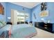 Bedroom showcasing blue walls, ample closet space, and natural light at 1886 Killdeer Ct, Venice, FL 34293