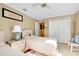 Bedroom featuring two twin beds, artwork, neutral decor, and a double closet door at 1886 Killdeer Ct, Venice, FL 34293