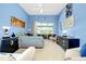 Light-filled bedroom with sliding glass doors, soft carpeting, and blue walls at 1886 Killdeer Ct, Venice, FL 34293