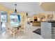 Bright dining area with table and chairs, adjacent to the kitchen and pool area at 1886 Killdeer Ct, Venice, FL 34293