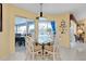 Cozy dining area with glass table, chairs, and a view of the pool at 1886 Killdeer Ct, Venice, FL 34293