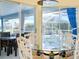 Intimate dining area featuring a glass table and views of the outdoor pool area at 1886 Killdeer Ct, Venice, FL 34293