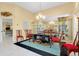 Formal dining room with decorative table, cabinet, large mirror, and modern lighting at 1886 Killdeer Ct, Venice, FL 34293