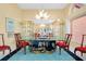 Elegant dining room featuring decorative table and cabinet, modern lighting, and tiled floors at 1886 Killdeer Ct, Venice, FL 34293