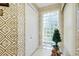 Hallway features a closet, glass brick window, and geometric wallpaper at 1886 Killdeer Ct, Venice, FL 34293