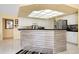 Bright kitchen with updated cabinets, modern appliances, and eye-catching island with unique stone detail at 1886 Killdeer Ct, Venice, FL 34293
