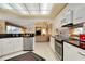Open kitchen featuring granite countertops, stainless steel appliances, and seamless flow to the living area at 1886 Killdeer Ct, Venice, FL 34293