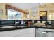 Kitchen area featuring granite countertops and stainless steel dishwasher at 1886 Killdeer Ct, Venice, FL 34293