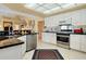 Bright kitchen featuring stainless steel appliances, sleek cabinets and granite countertops at 1886 Killdeer Ct, Venice, FL 34293