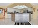 Bright kitchen with updated cabinets, modern appliances, and eye-catching island with unique stone detail at 1886 Killdeer Ct, Venice, FL 34293