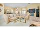 Spacious living area featuring a large sectional sofa and glass coffee tables at 1886 Killdeer Ct, Venice, FL 34293