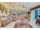 Open living room overlooking the kitchen with sliding glass doors to the pool at 1886 Killdeer Ct, Venice, FL 34293