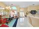 Open living and dining area featuring tile flooring, modern lighting, and glass double-door entry at 1886 Killdeer Ct, Venice, FL 34293