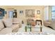 Sunlit living room showcasing comfortable seating, glass table, and eclectic décor at 1886 Killdeer Ct, Venice, FL 34293