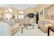 Open living space with a comfortable sofa, glass table, and stylish decorations at 1886 Killdeer Ct, Venice, FL 34293