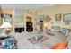 Bright living room with fireplace, tile floors, high ceilings, and comfortable leather sofa at 1886 Killdeer Ct, Venice, FL 34293