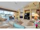 Spacious living room with tile floors, fireplace, and seamless access to the outdoor pool area at 1886 Killdeer Ct, Venice, FL 34293