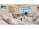 Well-lit living room boasting neutral furniture, glass coffee table, and outdoor views at 1886 Killdeer Ct, Venice, FL 34293