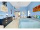 Spacious main bedroom featuring blue walls, plush carpet, and a seating area with a beautiful view at 1886 Killdeer Ct, Venice, FL 34293