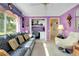 Office features a black sofa, desk, white walls, and large windows at 1886 Killdeer Ct, Venice, FL 34293