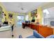 Yellow office space with a desk, blue chair, and sliding glass doors to an outdoor pool area at 1886 Killdeer Ct, Venice, FL 34293