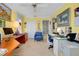 Bright office space with yellow walls, dual desks, a blue chair, and ample natural light at 1886 Killdeer Ct, Venice, FL 34293