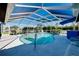 This caged in pool features a bar, railing, and plenty of sunlight on the inside at 1886 Killdeer Ct, Venice, FL 34293