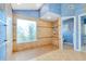 Elegant walk-in shower featuring decorative tile, a frosted window with floral design, and a convenient shower seat at 1886 Killdeer Ct, Venice, FL 34293